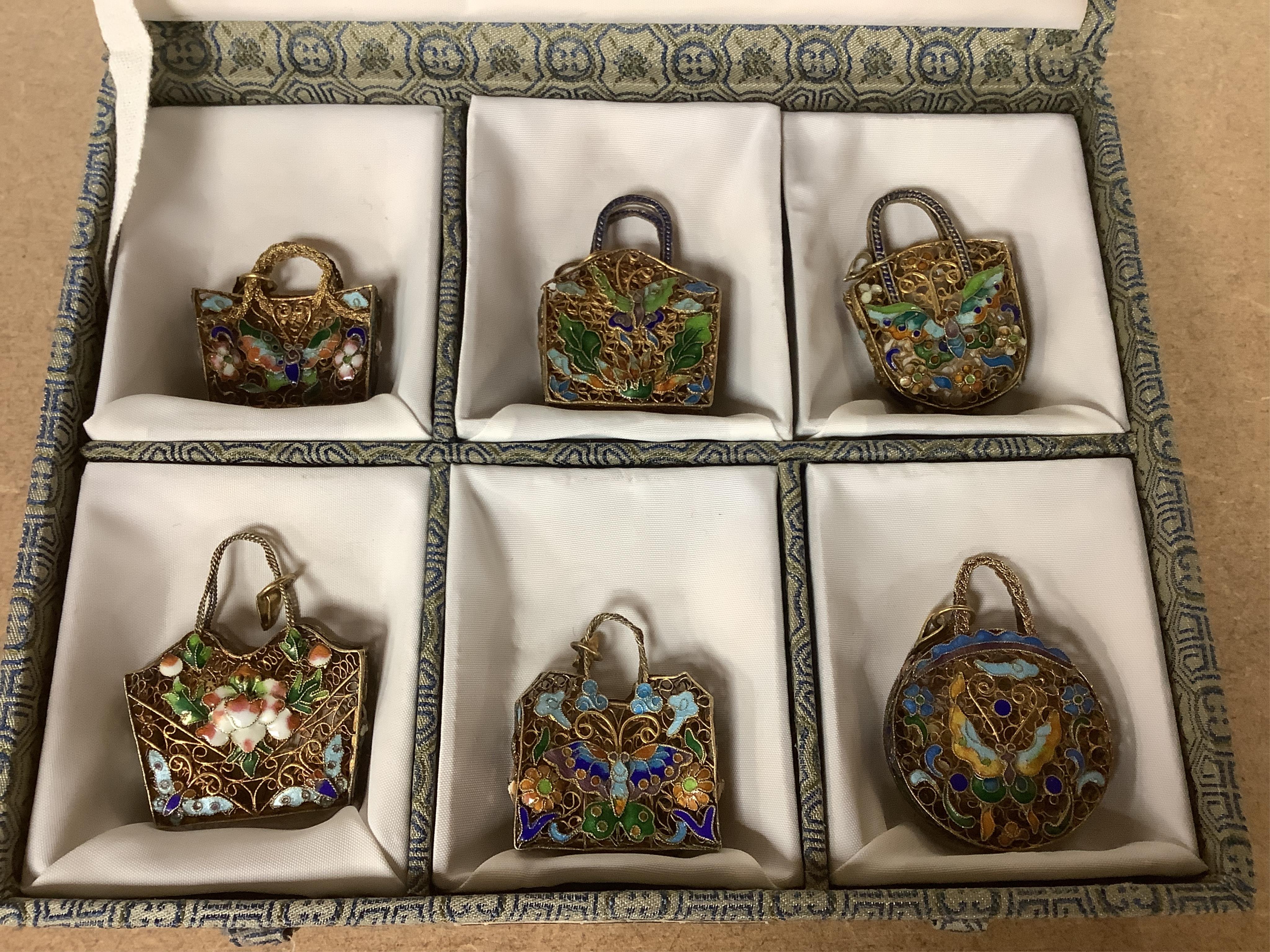 A cased set of Chinese gilt metal and enamel miniature bags. Condition - fair